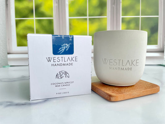 Westlake Handmade candle and packaging on a marble surface with a window in the background
