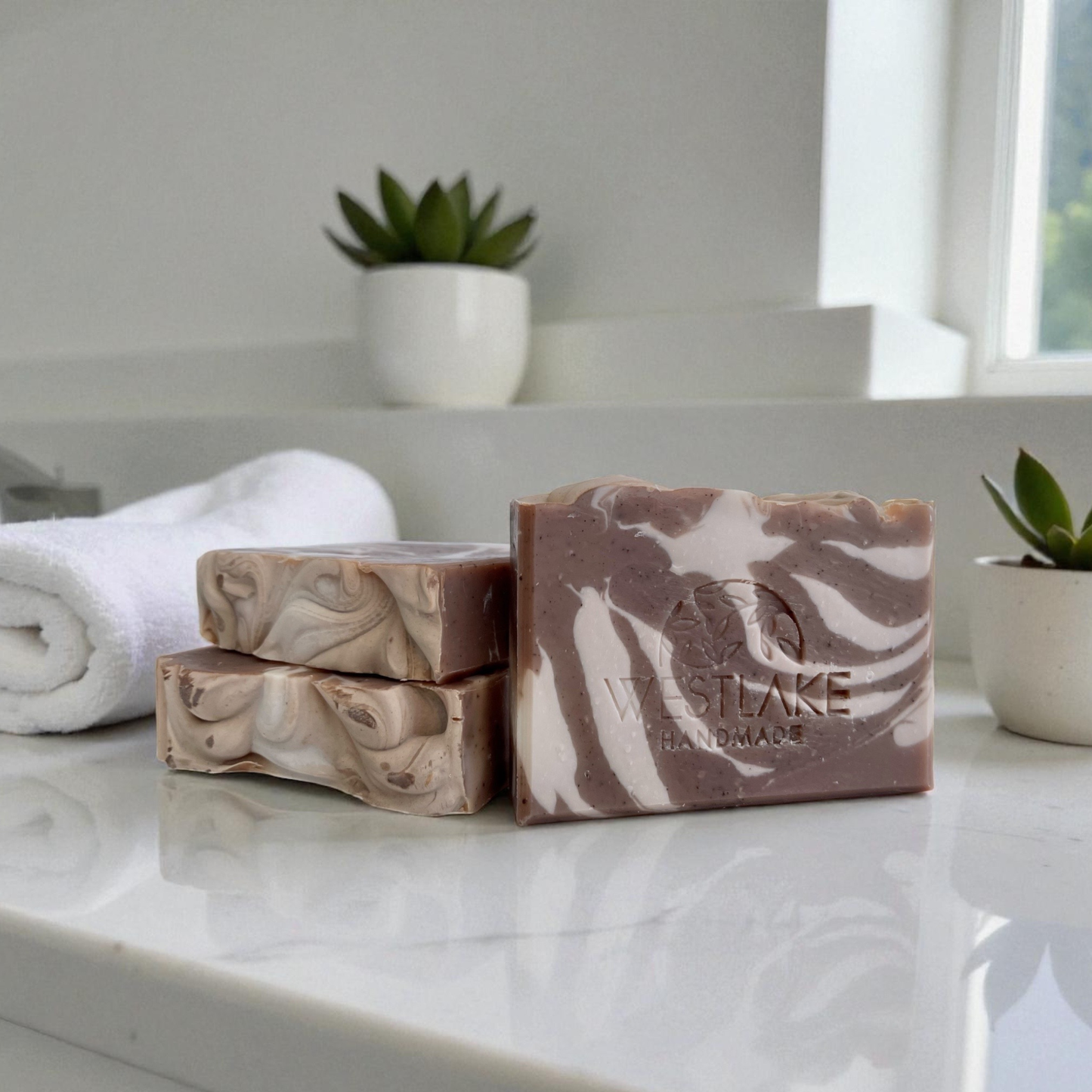Marble-patterned soap bars on a bathroom counter with 'Wastlake Handmade' branding.