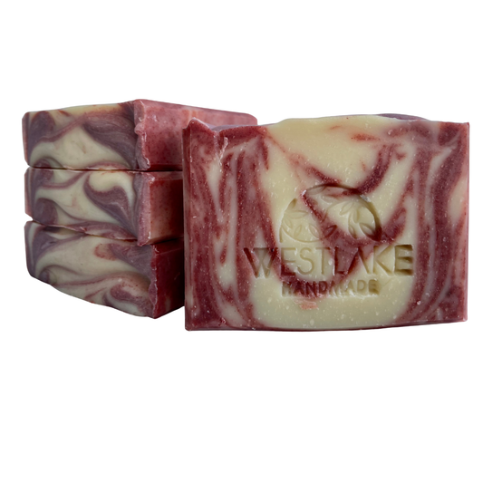 Marbled red and white soap bars with 'Westlake Handmade' branding on a white background