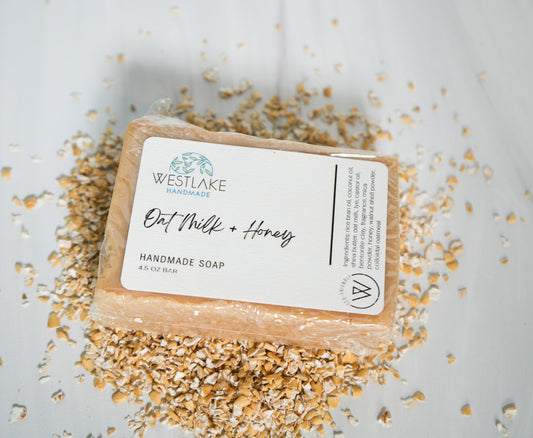 Handmade soap bar with 'Westlake Handmade' label on a light background with oats around