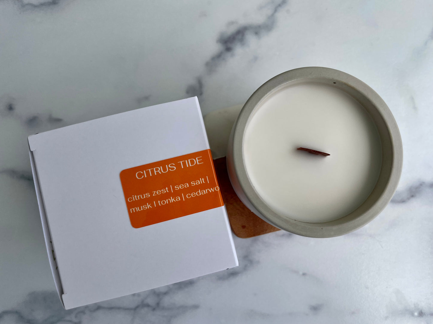 Westlake Handmade concrete candle with 'Citrus Tide' packaging on a marble surface