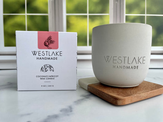 Westlake Handmade candle and packaging on a marble surface with a window in the background