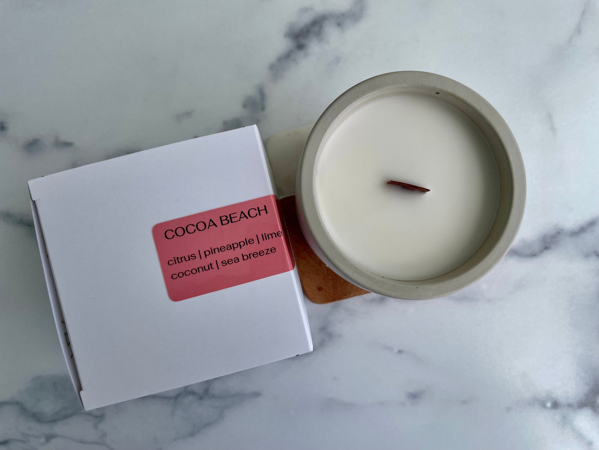 Westlake Handmade concrete candle with 'Cocoa Beach' packaging on a marble surface