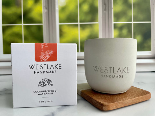 Westlake Handmade candle and packaging on a surface with a window in the background