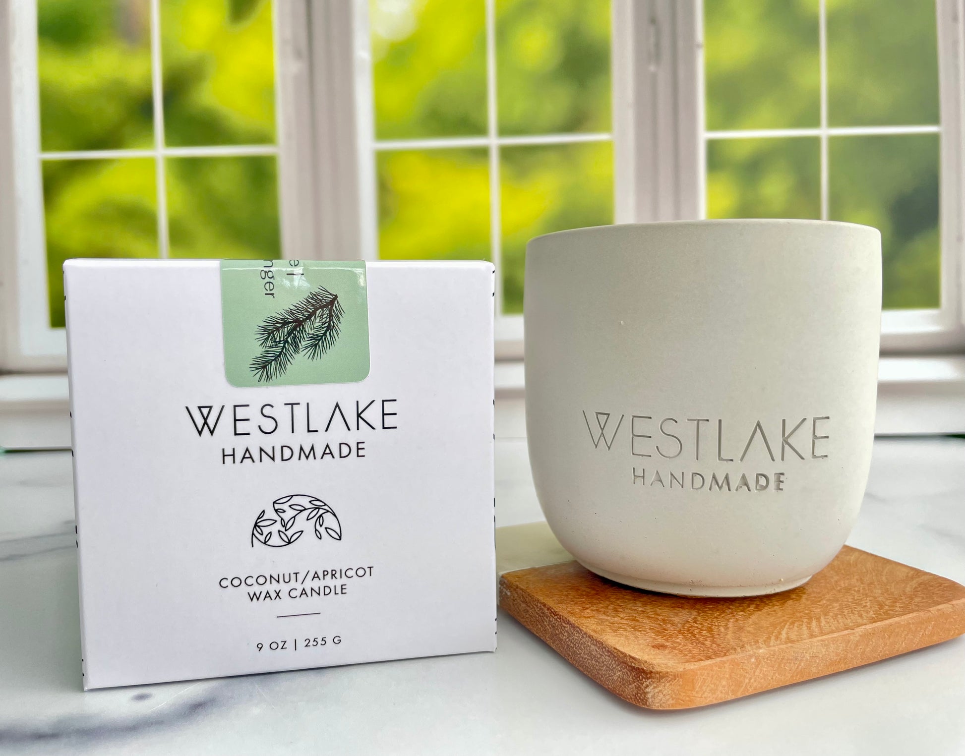 Westlake Handmade candle and packaging on a windowsill with a natural background