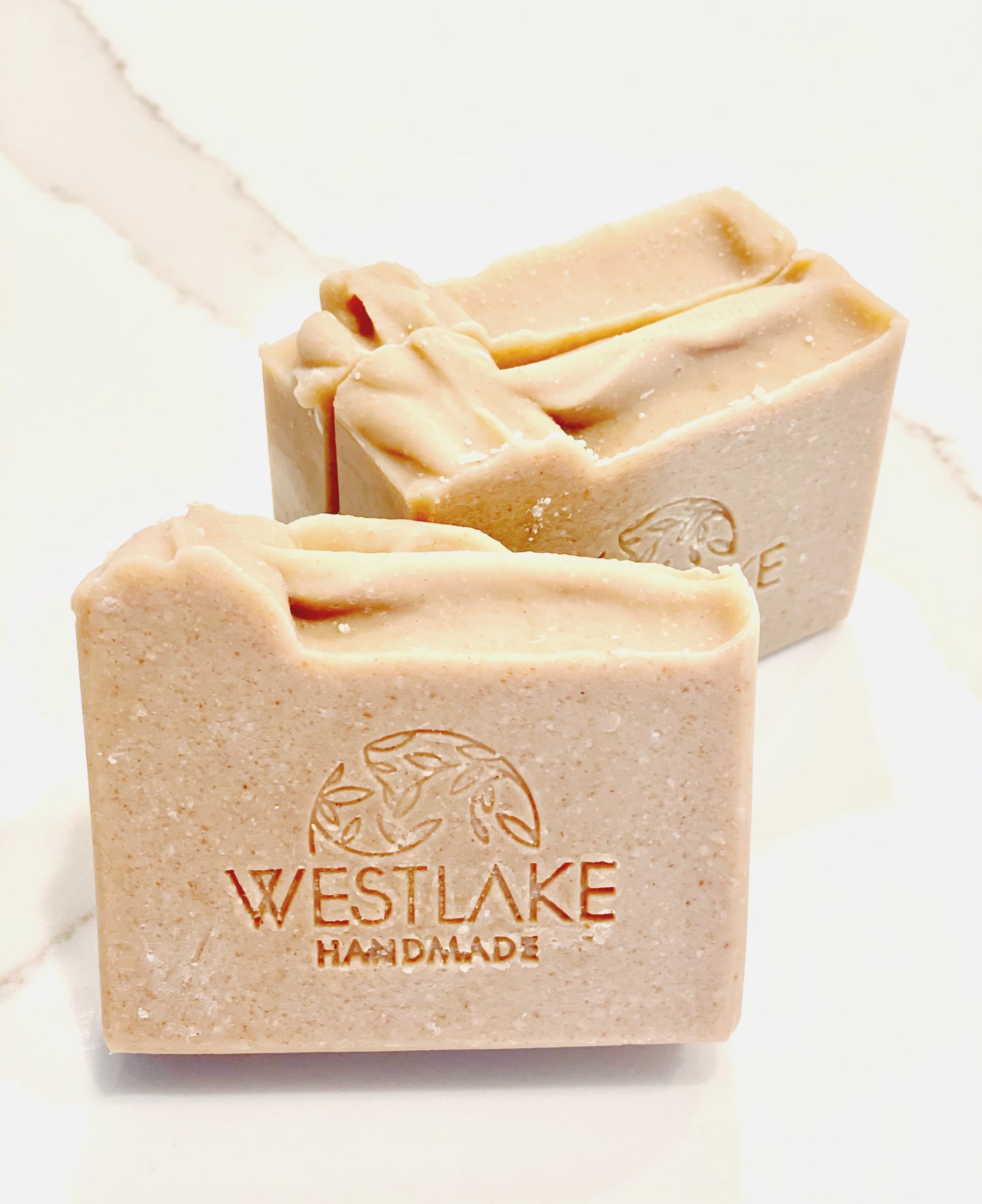 Three bars of Westlake Handmade soap on a light background