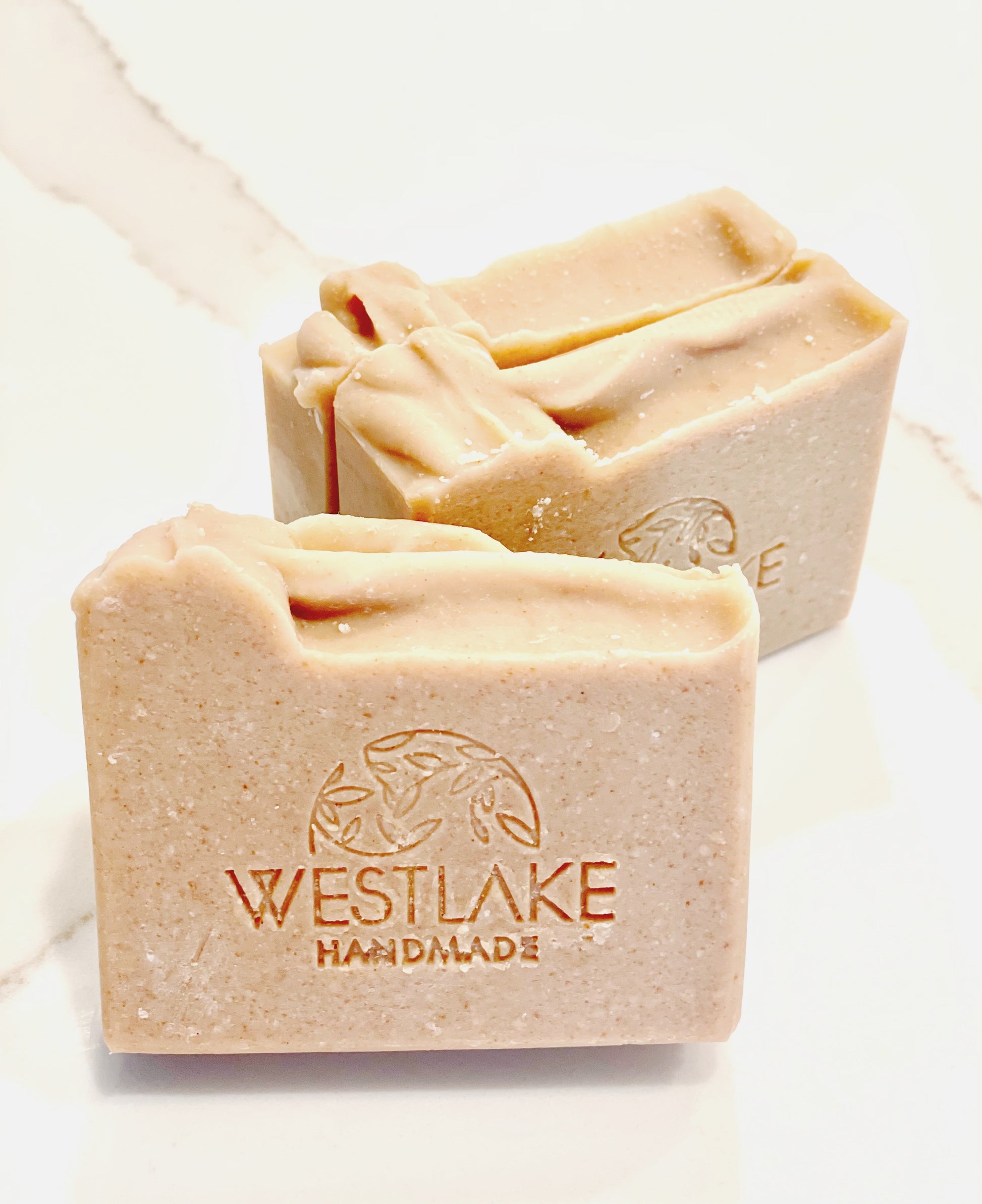 Three bars of Westlake Handmade soap on a light background