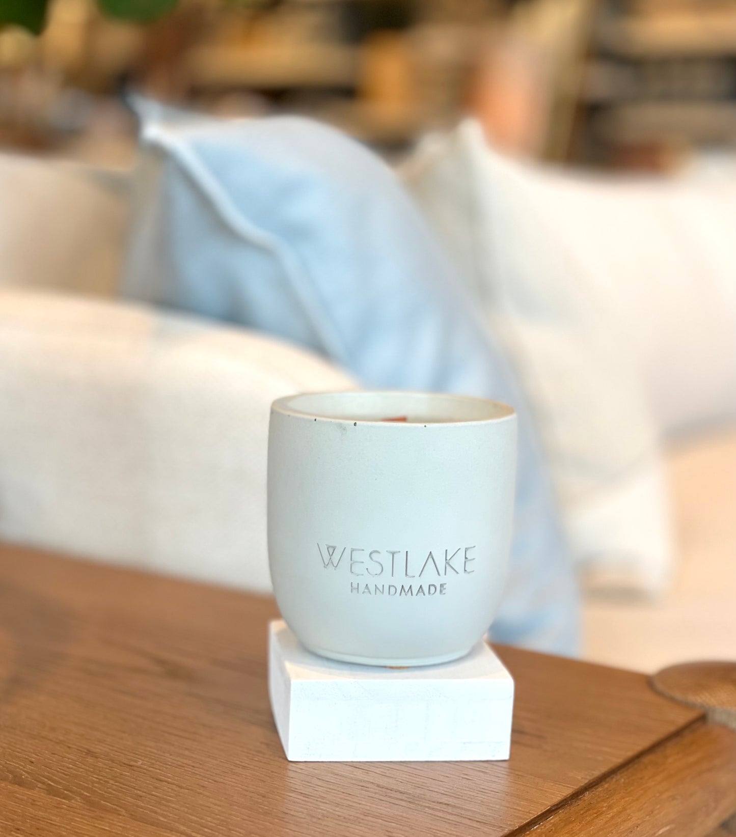 Westlake Handmade concrete candle on a wooden surface.