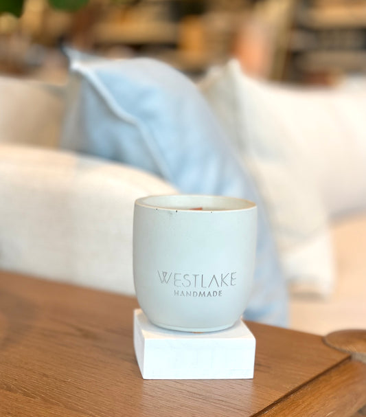 Westlake Handmade concrete candle on a wooden surface.