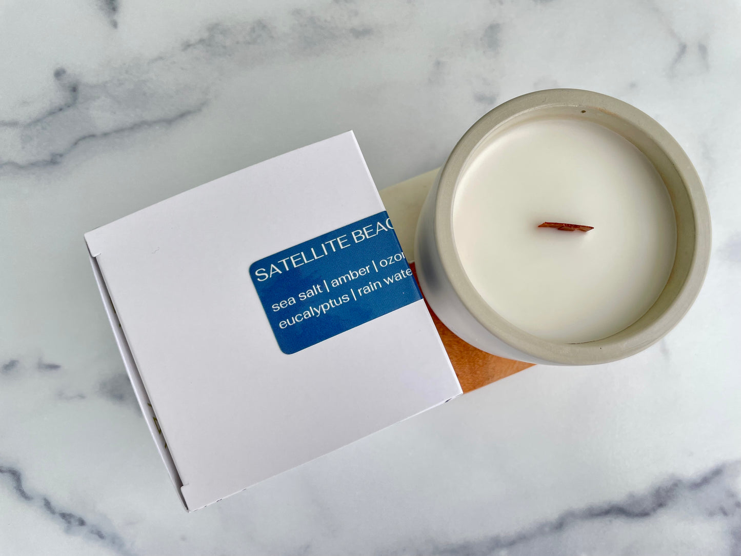 Westlake Handmade concrete candle in a white container with a label on a marble surface