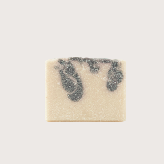 Rectangular bar of soap with blue swirls on a light gray background