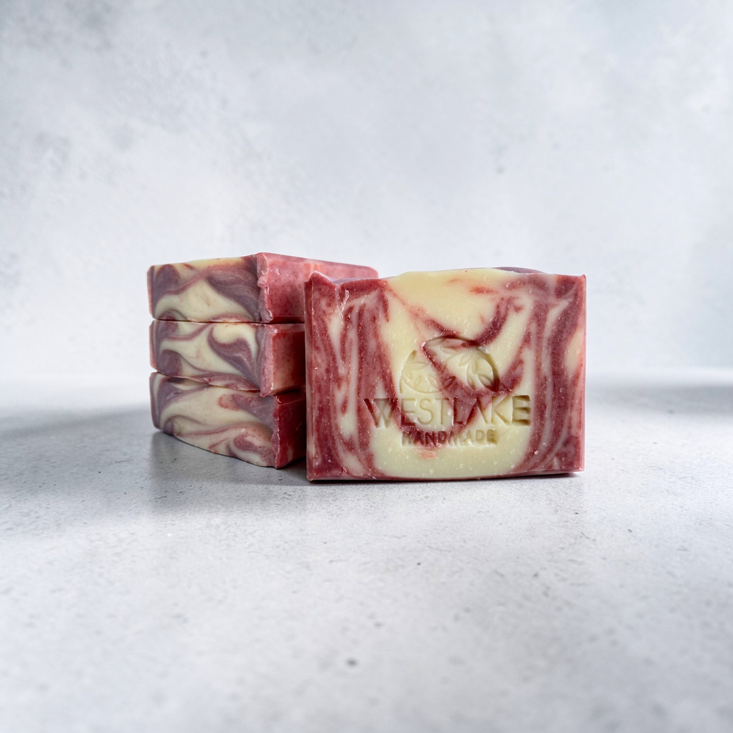 Three bars of marbled soap with 'Westlake Handmade' branding on a light gray background